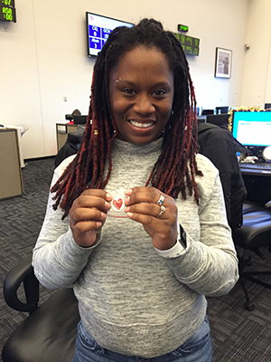 Desirae Dammons is pictured with OUC’s “Life Saver” pin on the main OUC Call Floor.