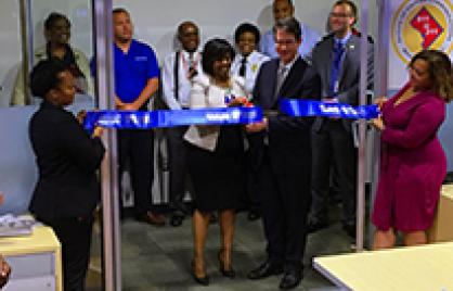 A group of people cutting the ribbon at the Call Simulation Lab